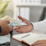 Two people exchanging cash.