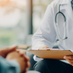 Physician in white coat holds clipboard, representing concierge medicine and Medicare.